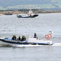 Greencastle Boat Tours out on tour with the ferry and the pier in the back ground