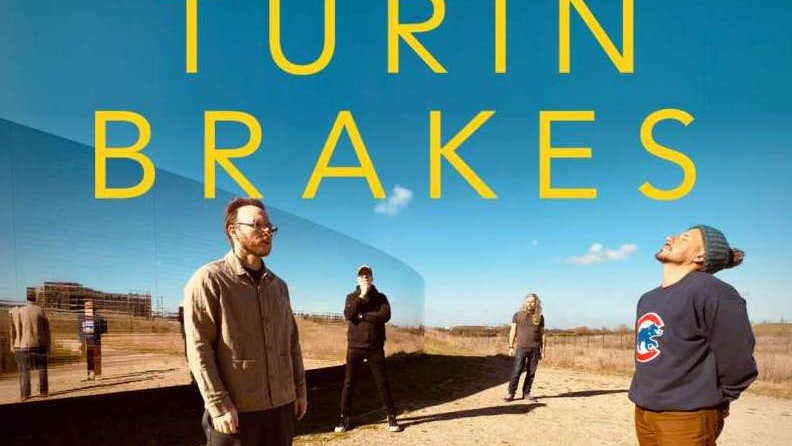 Group of 4 people standing spaced apart in random manner in a desert area with bright blue sky