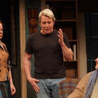 3 people on a stage in a discussion.