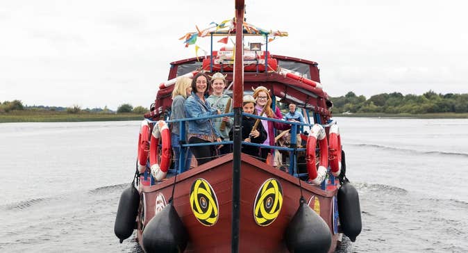 People cruising the River Shannon on board a Viking themed boat with Viking Tours