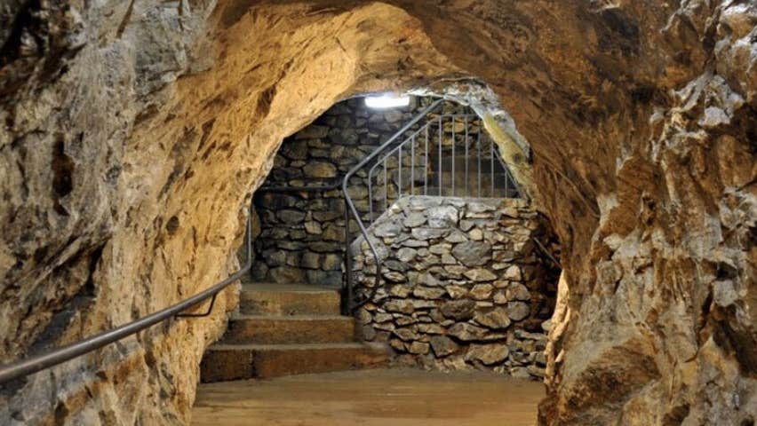 Inside the Glengowla Mine with steps in the distance and a hand rail in the foreground