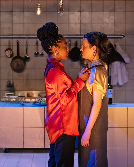 The Lir Academy view of two people in an emotional performance in a kitchen scene on stage