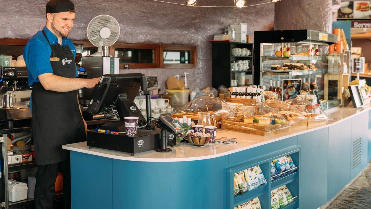 Staff member at a counter in a café