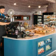 Staff member at a counter in a café