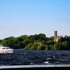 A boat sailing past a castle on Lough Key in Roscommon