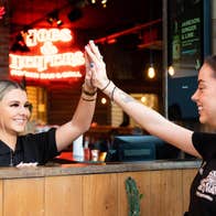 Staff high fiving at Hogs & Heifers Bar & Grill Liffey Valley