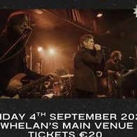 Dublin indie rock band Dakota 66, 3 men on a dark stage playing and singing