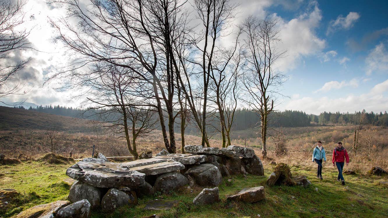 Two people walking through the natural landscape of the Cavan Burren Park, one of the best things to do in Cavan