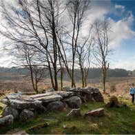 Two people walking through the natural landscape of the Cavan Burren Park, one of the best things to do in Cavan