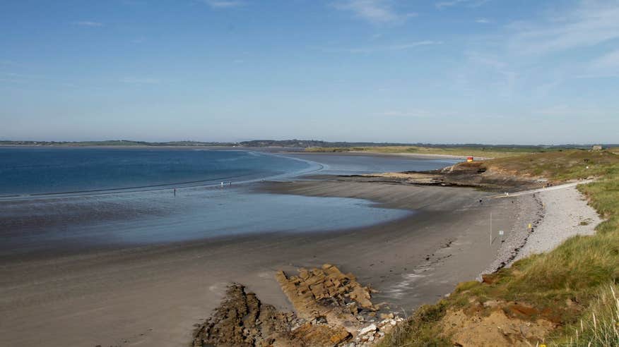 Still blue water and sand dunes at Rosses Point, Sligo