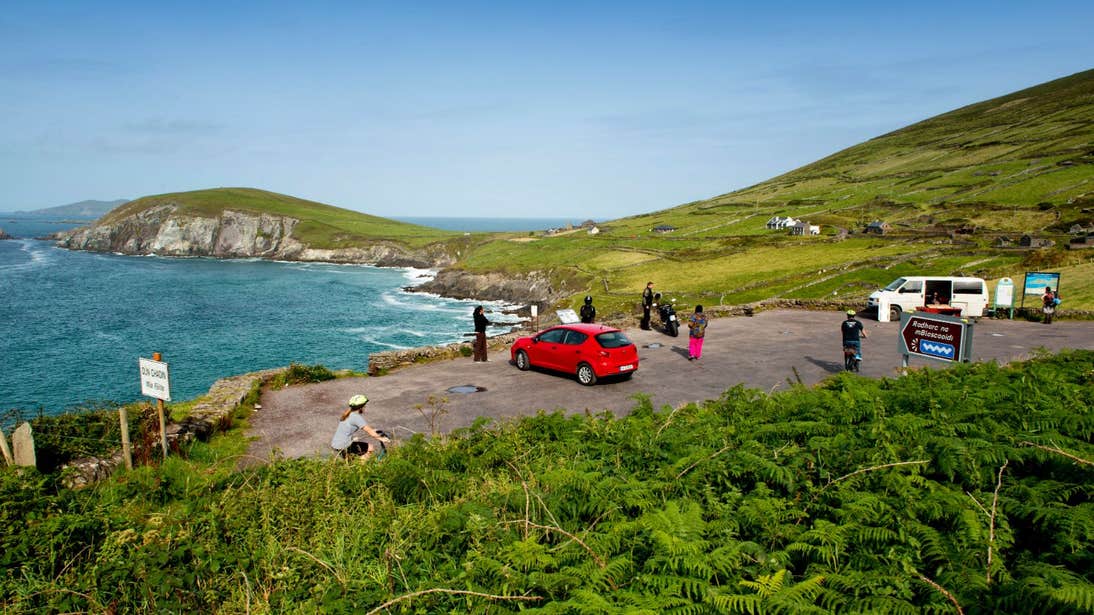Groups of drivers and cyclists taking the view at Slea Head, Co. Kerry