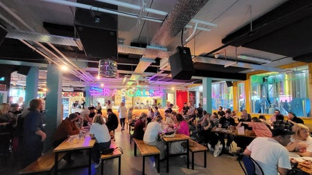 A busy dining area with lots of people seated