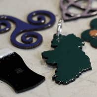 Introduction to Enamel Workshop, different enamel shapes ie a map of Ireland, a shamrock, a pint of Guinness.