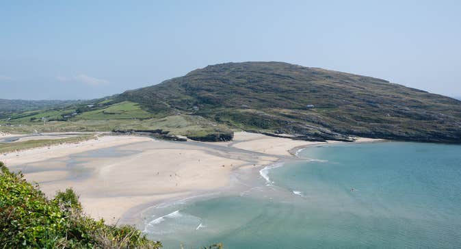 A view of Barley Cove sandy beach sea and surrounding hills