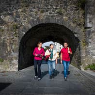 Friends walking through the Spanish Arch, Galway City