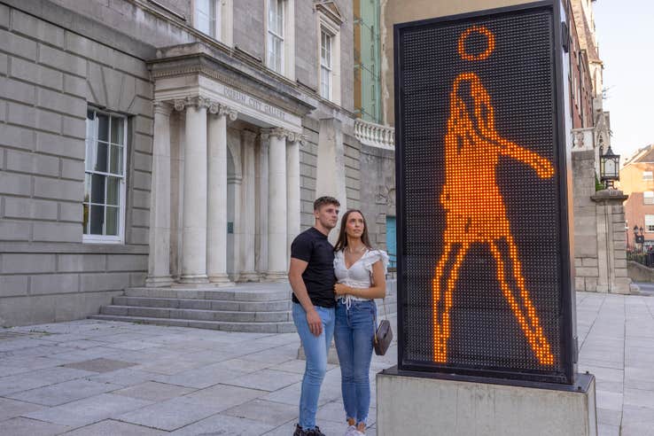 A couple admiring the modern art installation outside of the Hugh Lane Gallery in Dublin city.