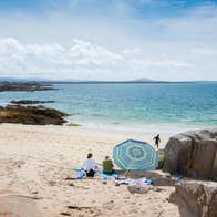 A group of people on Gurteen Beach, Galway on a sunny day
