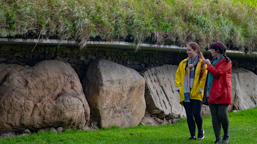 People looking at the kerbstones at Knowth, Co Meath