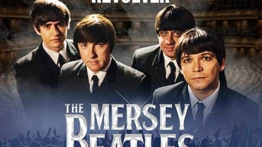 4 men in dark suits and ties looking slightly upwards as camera