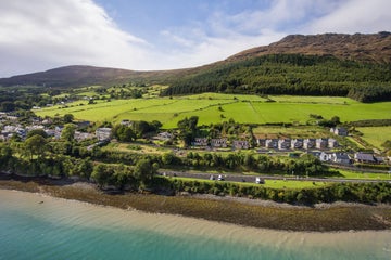 An aerial view of water and green hills in Carlingford