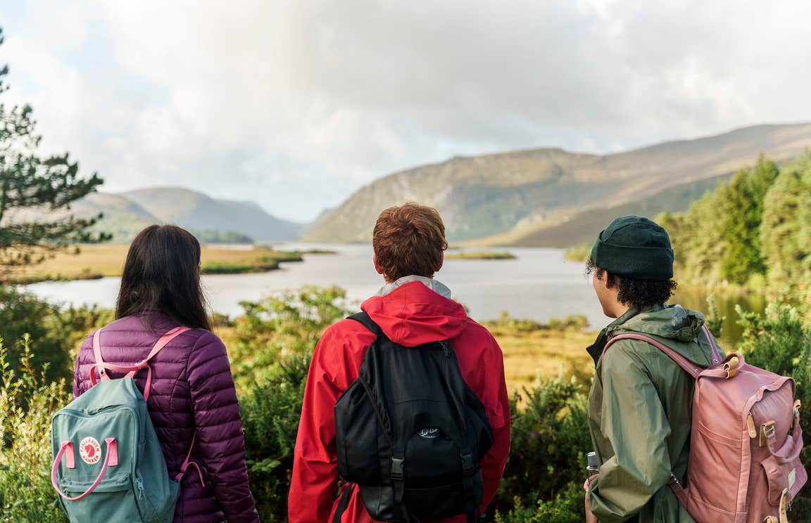 Three people looking out over the loughs at Glenveagh National Park in Letterkenny, County Donegal.