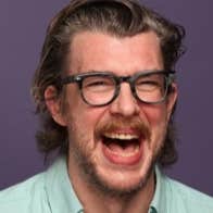 A man laughing with his mouth wide open.