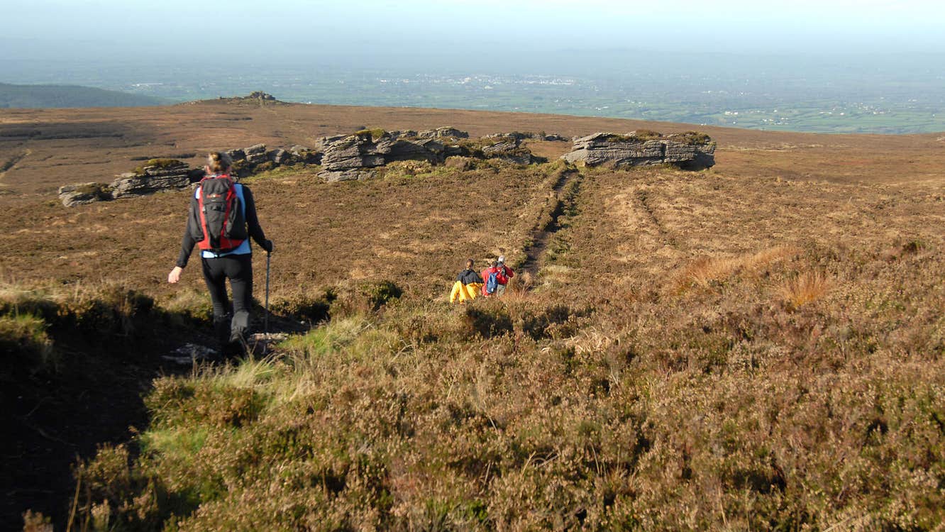 Walkers on a mountain with view into the countryside