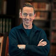 A smiling man with crossed arms