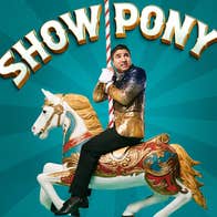 An anxious looking man in a gold sparkly jacket on the back of a decorated horse from a merry go round, clinging onto the stripy upright pole