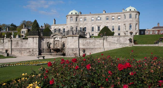Red and yellow roses on a lawn outside Powerscourt House and Gardens
