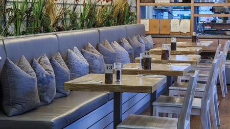 The interior of a café with bench seating and cushions