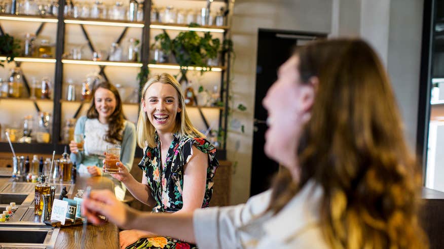 Three women enjoying a tour of Roe & Co Distillery in Dublin City.