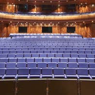 A view from a stage onto an empty seating area surrounded by a balcony