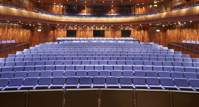 A view from a stage onto an empty seating area surrounded by a balcony