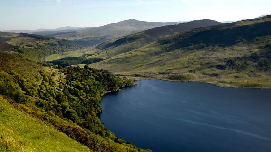 Blue lake set in the middle of rolling green hills in the Wicklow Mountains, Wicklow.