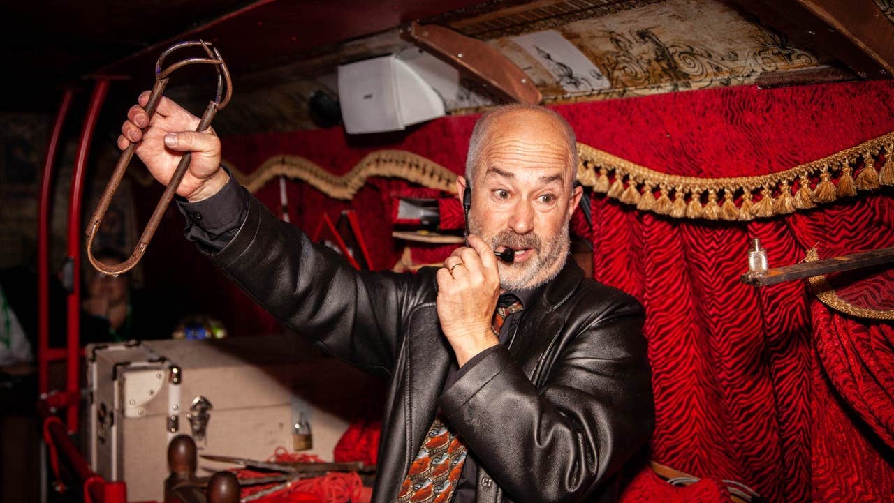 A bus tour guide giving a ghost tour on a bus