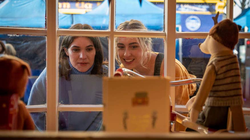 Two women looking in the window of an antique shop in Galway City.