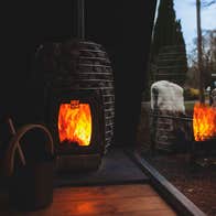 Fire for the sauna with bright flames reflected in the window