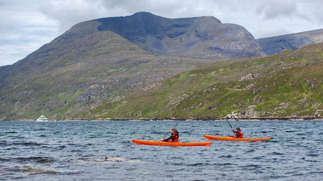 Two people kayaking across Killary Harbour in Galway.