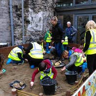 The Big Dig: A Viking Adventure for Kids, children digging with buckets in a large sand pit