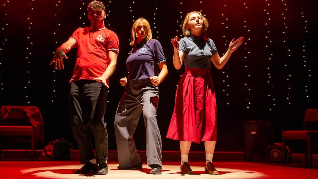 3 people on a stage in different dance moves