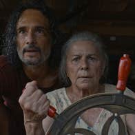 A worried looking older man and woman looking ahead.