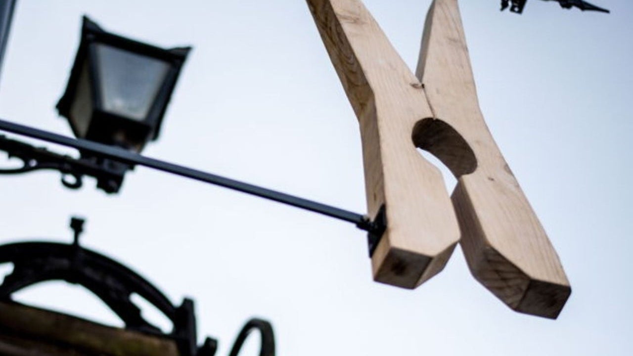A large clothes peg sign outside The Washerwoman restaurant