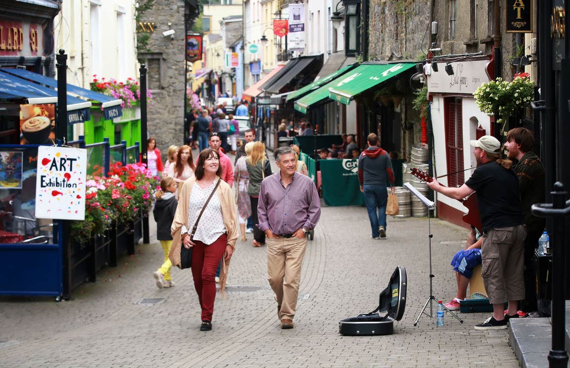 Couple walking down lively streets in Kilkenny City 