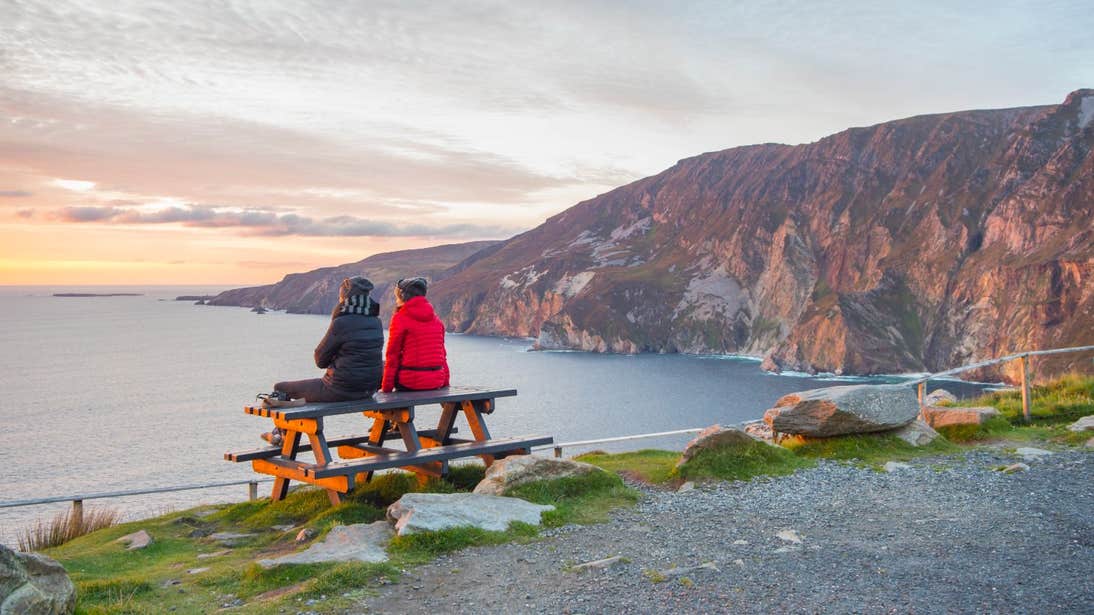 Two friends sitting on a table at Slieve League in Co. Donegal.