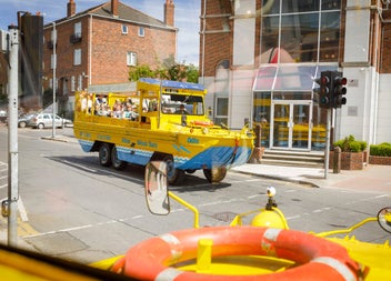 A land boat with passengers on a city street