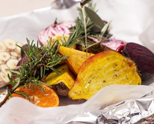 A dish of roasted vegetables and fruit