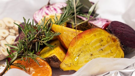 A dish of roasted vegetables and fruit
