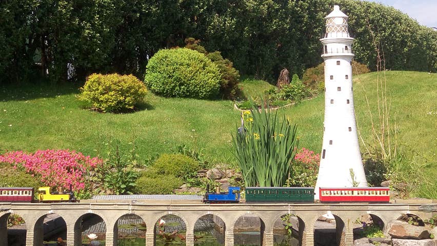 Miniature train going over a miniature railway viaduct at West Cork Model Railway Villiage