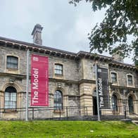 Stone exterior of a gallery building with steps leading up to it